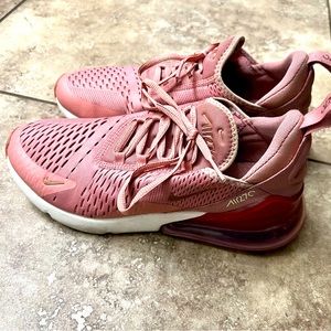 Women’s rose gold Nike athletic shoes